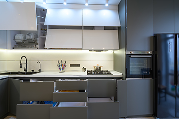 Image showing Luxury white and dark grey modern kitchen interior, front view