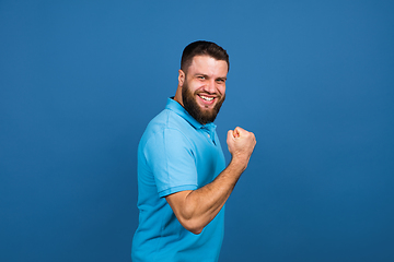 Image showing Caucasian man\'s portrait isolated on blue studio background with copyspace