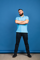 Image showing Caucasian man\'s portrait isolated on blue studio background with copyspace