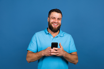 Image showing Caucasian man\'s portrait isolated on blue studio background with copyspace