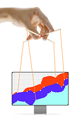 Image showing Businessman keeping the growth in economy, manipulating graphs like puppet