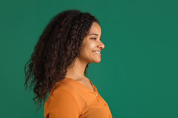 Image showing African-american woman portrait isolated on green studio background with copyspace