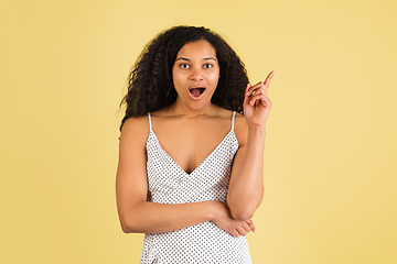 Image showing African-american woman portrait isolated on yellow studio background with copyspace