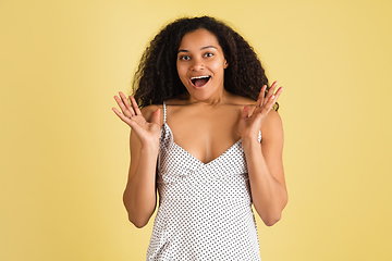 Image showing African-american woman portrait isolated on yellow studio background with copyspace