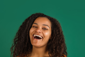 Image showing African-american woman portrait isolated on green studio background with copyspace