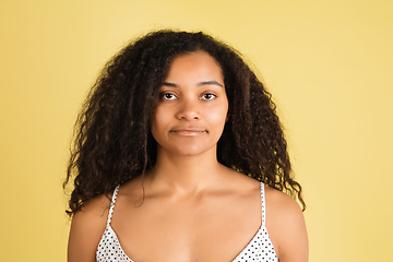 Image showing African-american woman portrait isolated on yellow studio background with copyspace