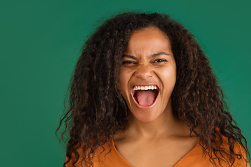 Image showing African-american woman portrait isolated on green studio background with copyspace