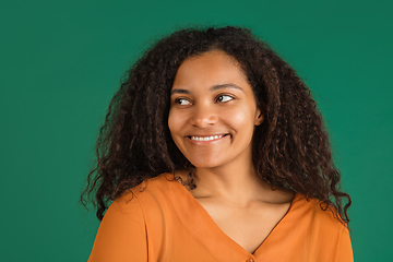 Image showing African-american woman portrait isolated on green studio background with copyspace