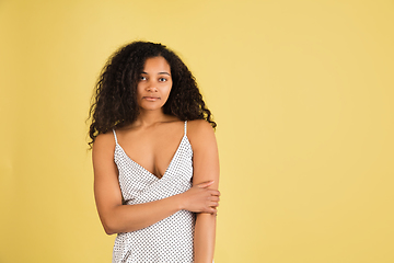 Image showing African-american woman portrait isolated on yellow studio background with copyspace