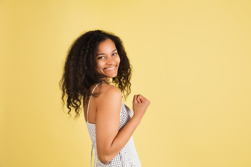 Image showing African-american woman portrait isolated on yellow studio background with copyspace
