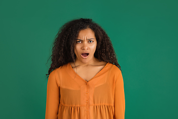 Image showing African-american woman portrait isolated on green studio background with copyspace