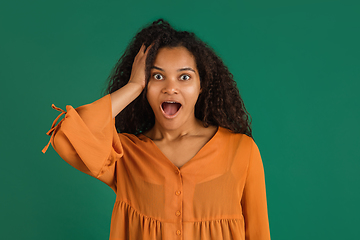 Image showing African-american woman portrait isolated on green studio background with copyspace