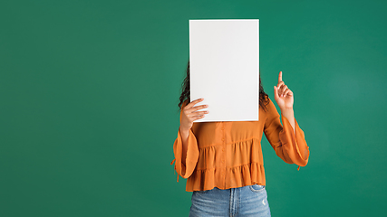 Image showing African-american woman portrait isolated on green studio background with copyspace