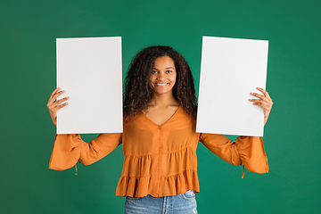 Image showing African-american woman portrait isolated on green studio background with copyspace