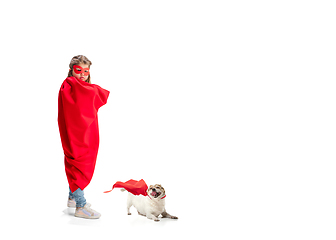Image showing Child pretending to be a superhero with her super dog isolated on white studio background