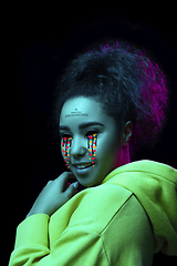 Image showing Tears illustrated of social media activity signs on female face in neon light. Real life versus online lifestyle, addiction to modern technologies