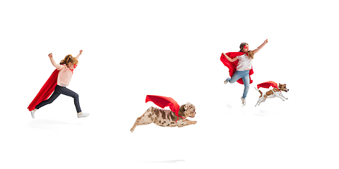 Image showing Children pretending to be a superhero with their super dog isolated on white studio background