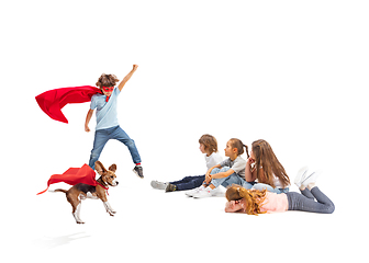 Image showing Child pretending to be a superhero with his super dog and friends sitting around