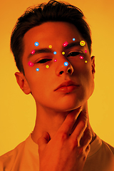 Image showing Tears illustrated of social media activity signs on male face in neon light. Real life versus online lifestyle, addiction to modern technologies