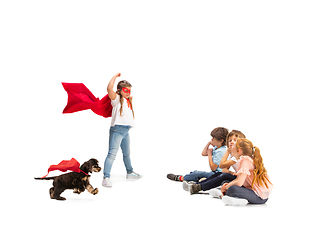 Image showing Child pretending to be a superhero with her super dog and friends sitting around