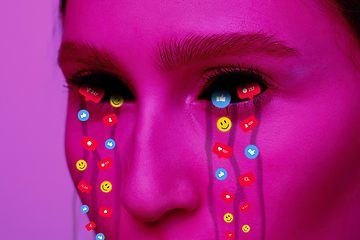 Image showing Tears illustrated of social media activity signs on female face in neon light. Real life versus online lifestyle, addiction to modern technologies