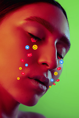 Image showing Tears illustrated of social media activity signs on female face in neon light. Real life versus online lifestyle, addiction to modern technologies