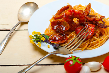 Image showing Italian seafood spaghetti pasta on red tomato sauce