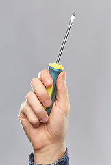 Image showing close up of builder's hand holding screwdriver