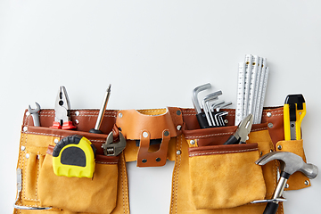 Image showing different work tools in belt on white background