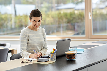 Image showing young woman with laptop working at home office