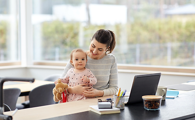 Image showing happy mother with baby working at home office