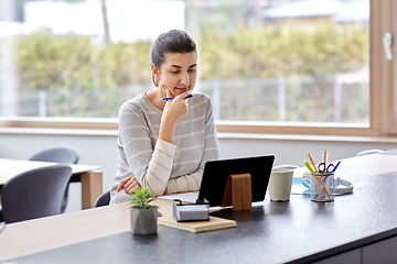 Image showing young woman with tablet pc working at home office