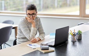 Image showing bored woman with laptop working at home office