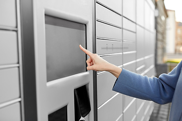 Image showing close up of hand using automated parcel machine