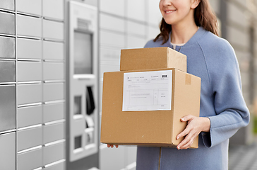 Image showing woman with boxes at automated parcel machine