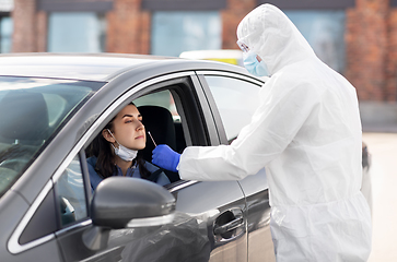 Image showing healthcare worker making coronavirus test at car