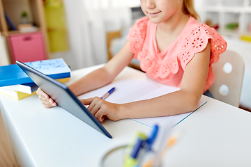 Image showing little student girl using tablet computer at home