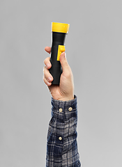 Image showing close up of builder's hand holding flashlight