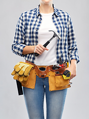 Image showing woman with hammer and working tools on belt