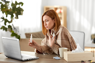 Image showing sick woman having video call on laptop at home