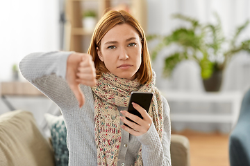 Image showing sick woman with smartphone showing thumbs down