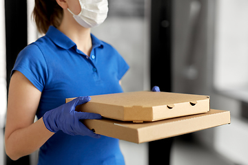 Image showing delivery woman in face mask with pizza boxes