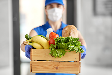 Image showing delivery woman in face mask with food in box