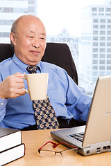 Image showing Working senior asian businessman