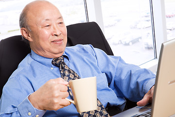 Image showing Working senior asian businessman