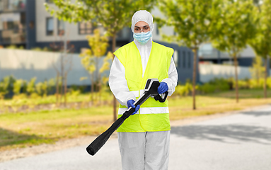 Image showing sanitation worker in hazmat with pressure washer