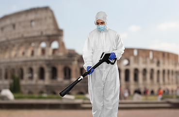 Image showing sanitation worker in hazmat with pressure washer