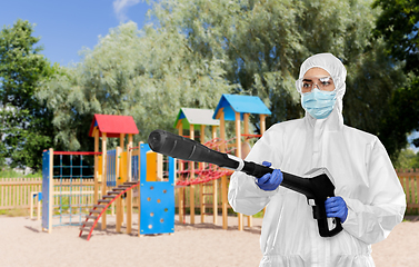 Image showing sanitation worker in hazmat with pressure washer