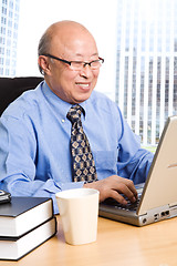 Image showing Working senior asian businessman