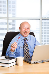 Image showing Working senior asian businessman